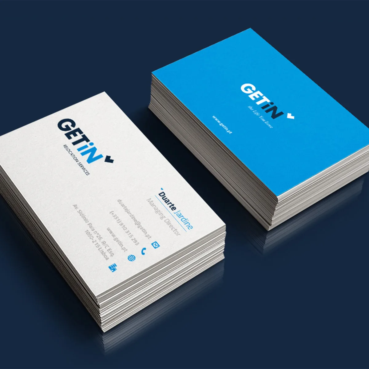 GETiN — business card mockup in white and blue on a dark navy surface