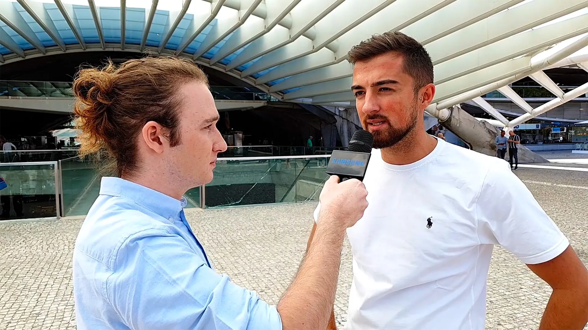 Samsung — video still of a street interview with a man holding a microphone