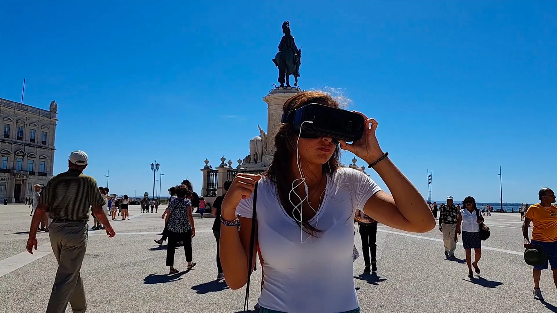 Samsung — video still of a woman wearing a VR headset in a busy city square
