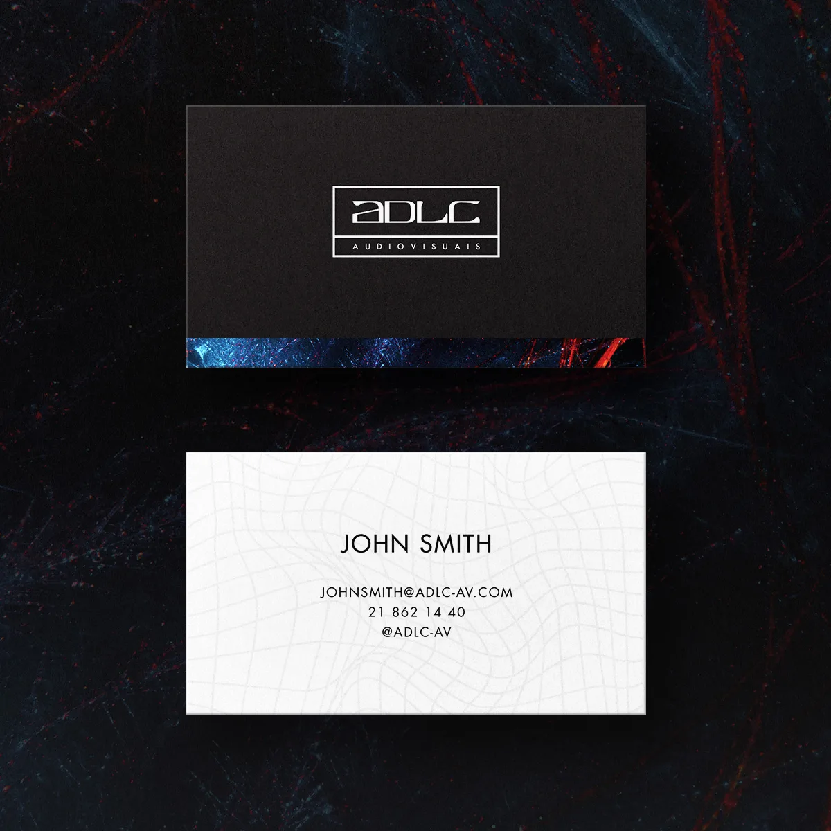 ADLC – Audiovisuais — black and white ADLC business cards, front and back, on a dark textured surface
