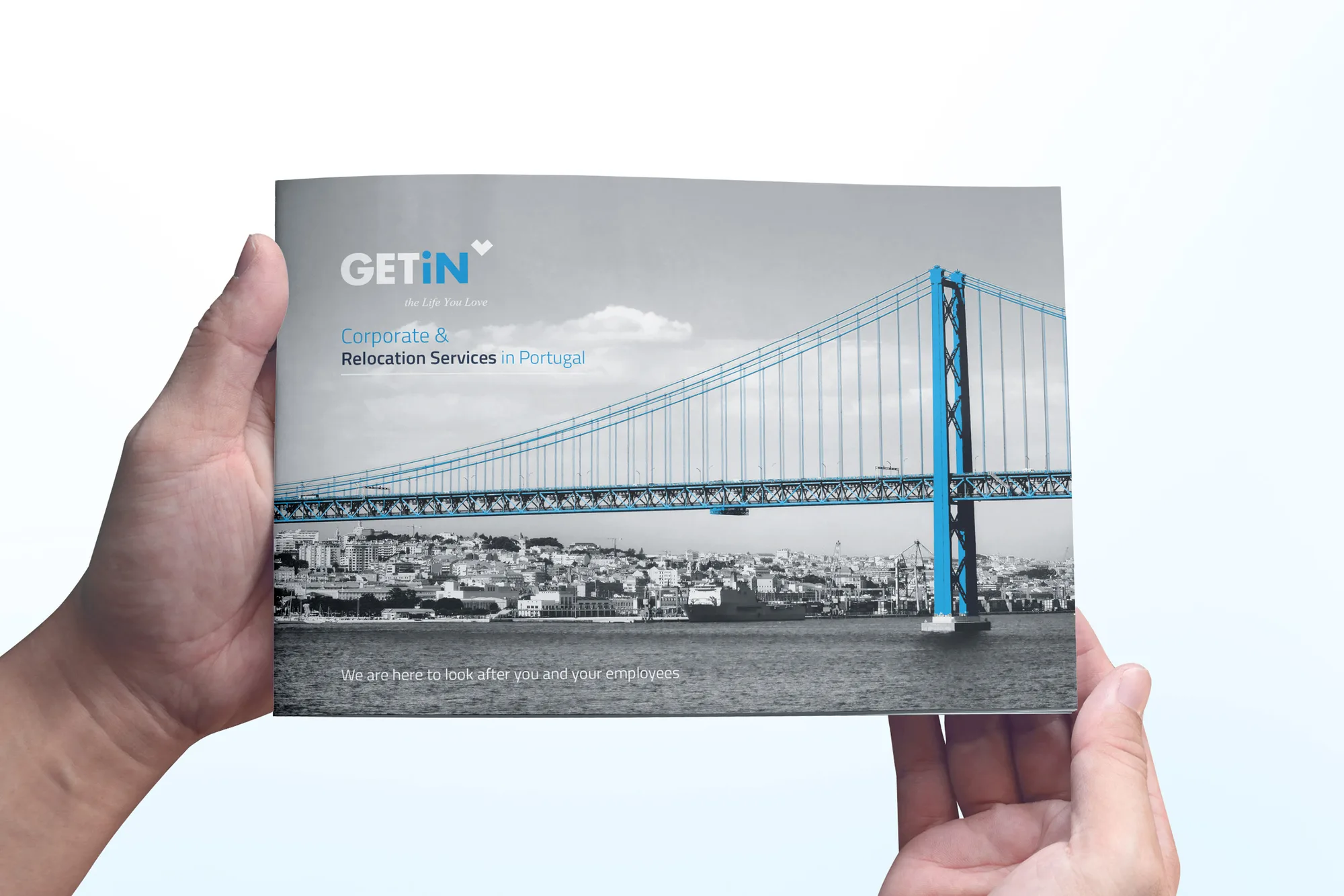 GETiN — hands holding a brochure cover with a bridge over Lisbon and the GETiN logo