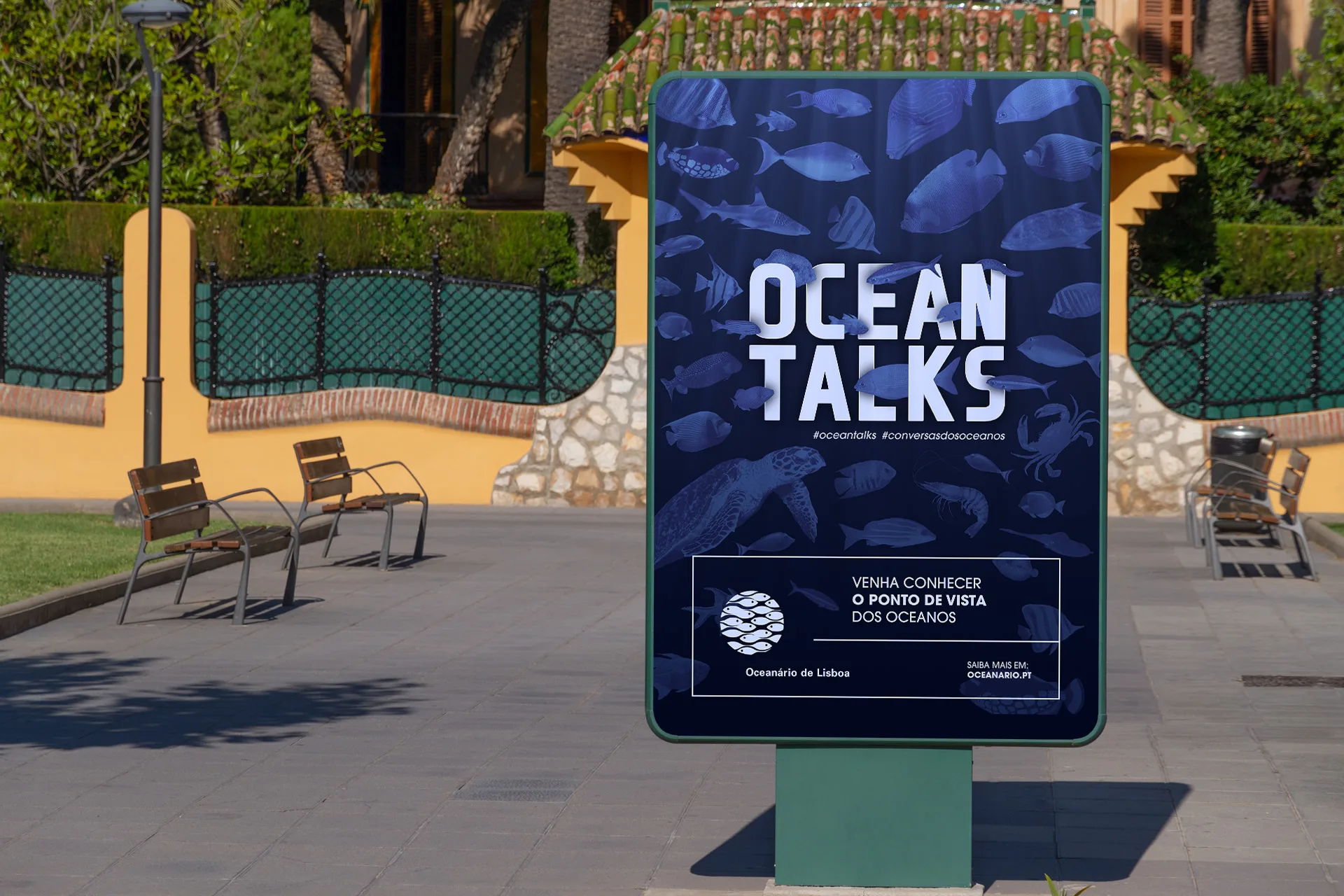 Oceanário de Lisboa – Oceanu — Ocean Talks poster mocked up on a street billboard in a park with benches