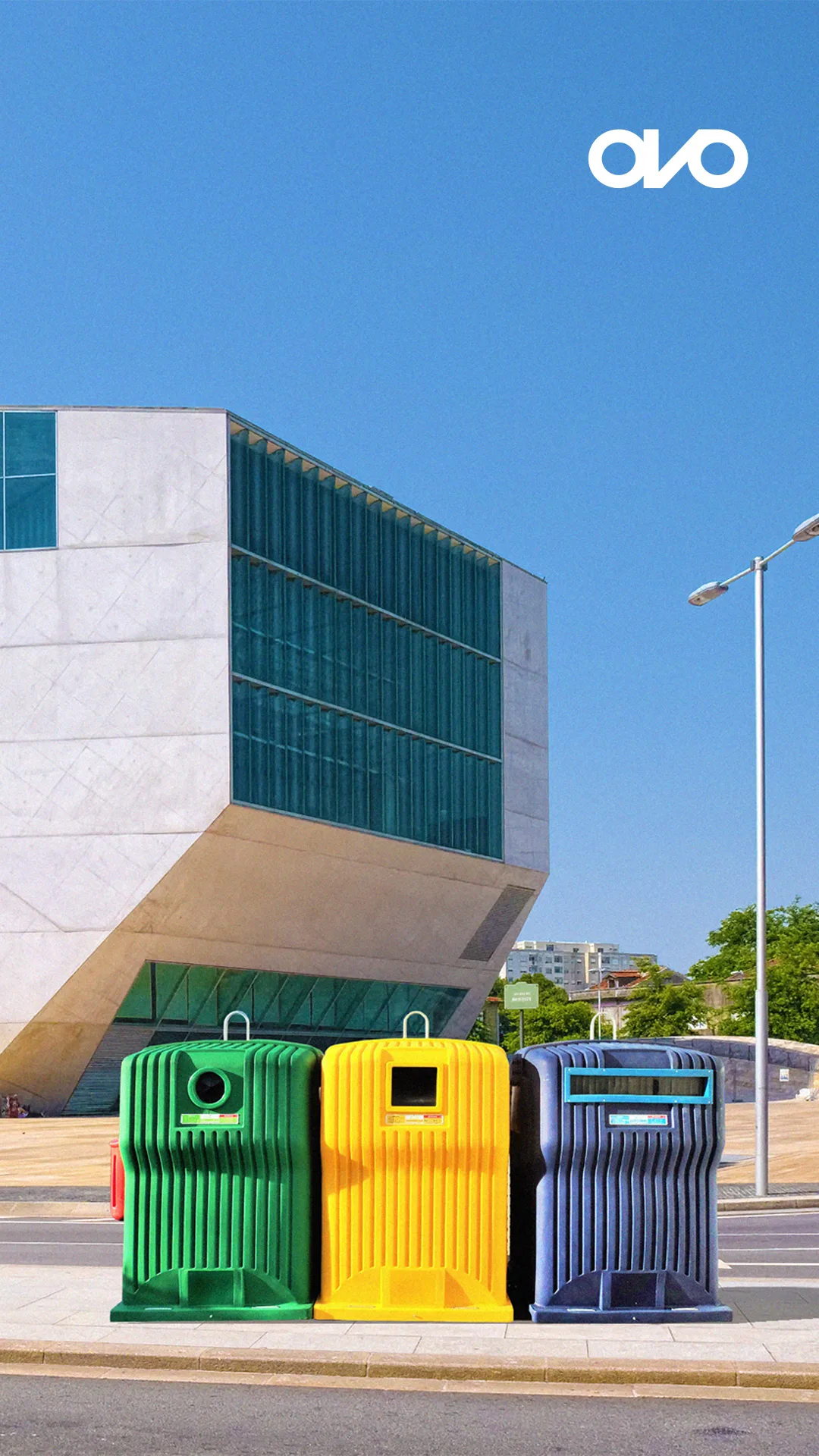 Ovo Solutions — green, yellow and blue recycling containers in front of a modern building