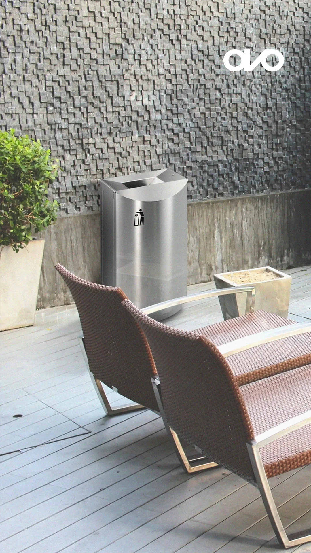 Ovo Solutions — stainless steel bin beside outdoor chairs on a terrace, with Ovo logo