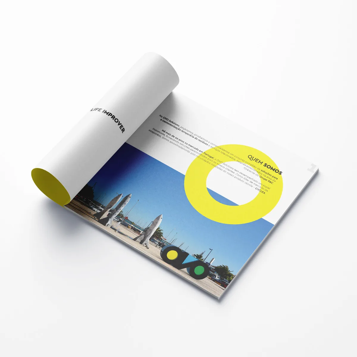 Ovo Solutions — rolled brochure spread with yellow ring graphic and waterfront photo