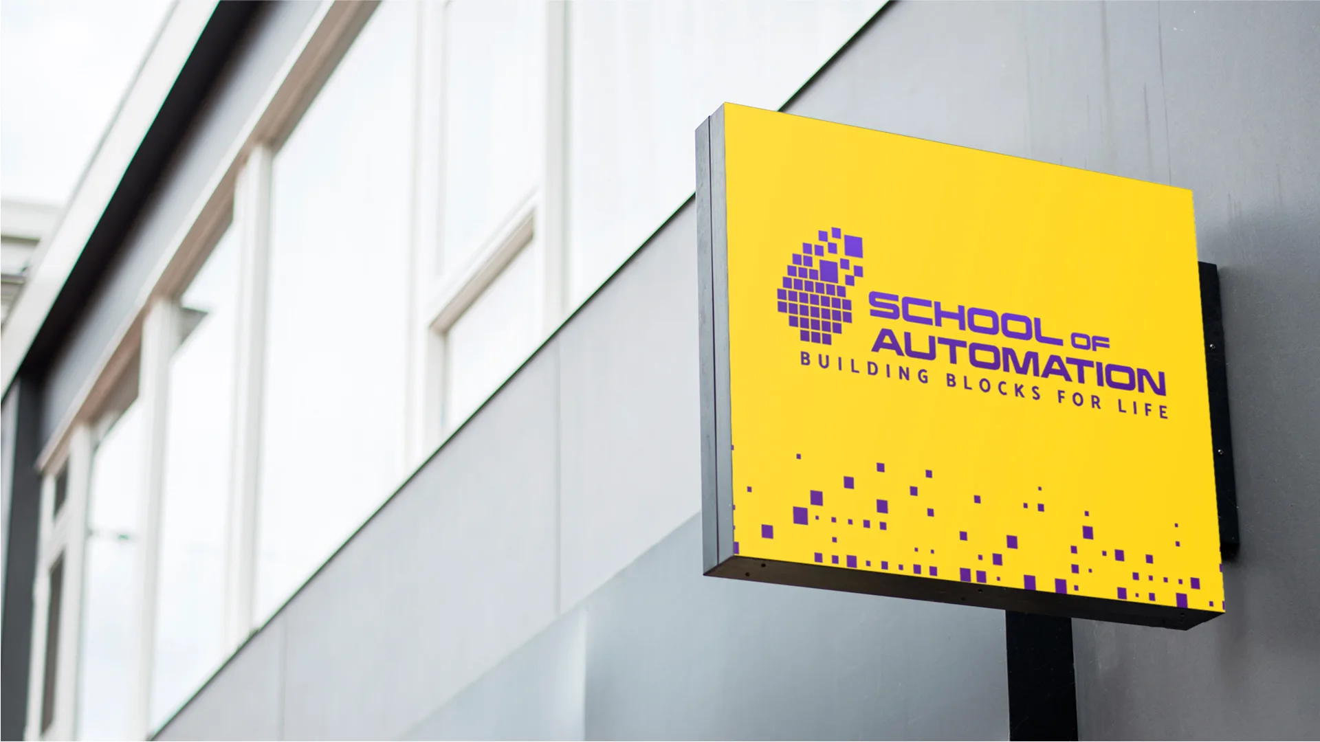 SOA – School of Automation — yellow wall-mounted sign with the School of Automation logo