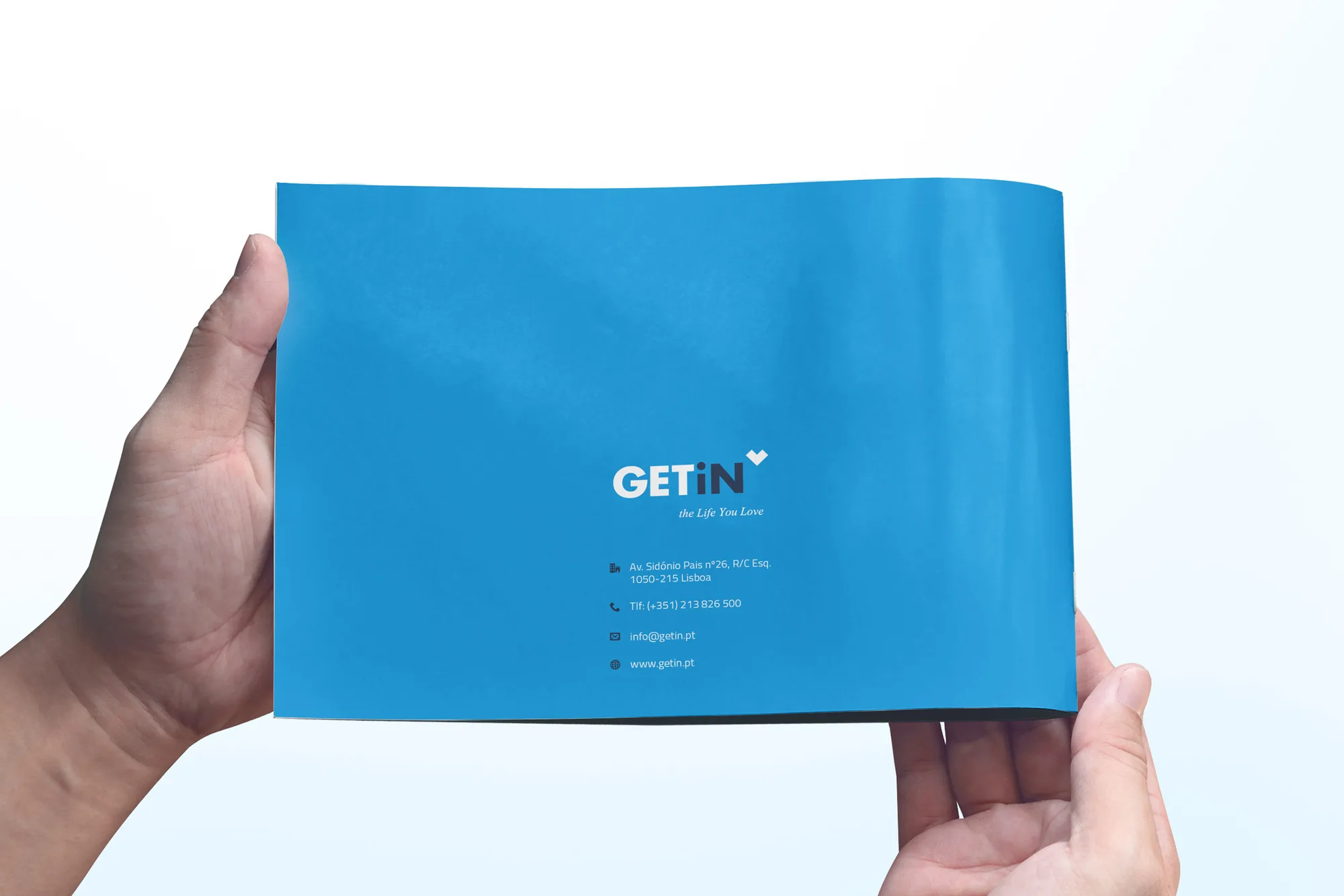 GETiN — hands holding a blue brochure back cover with the GETiN logo and contact details