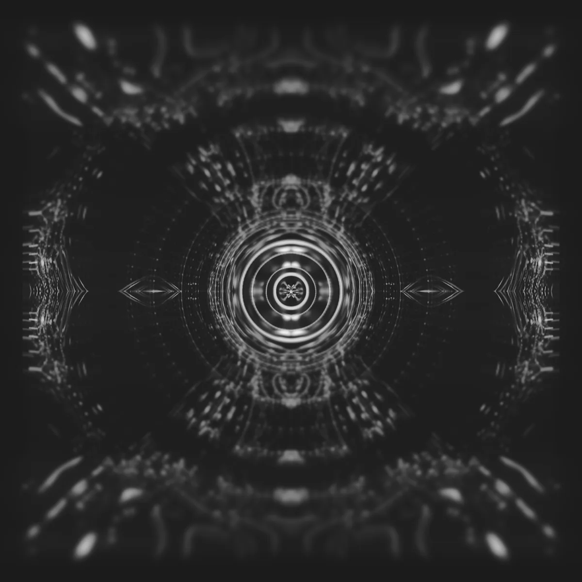 reakt0r — symmetrical white concentric rings and radial details on a dark grey background