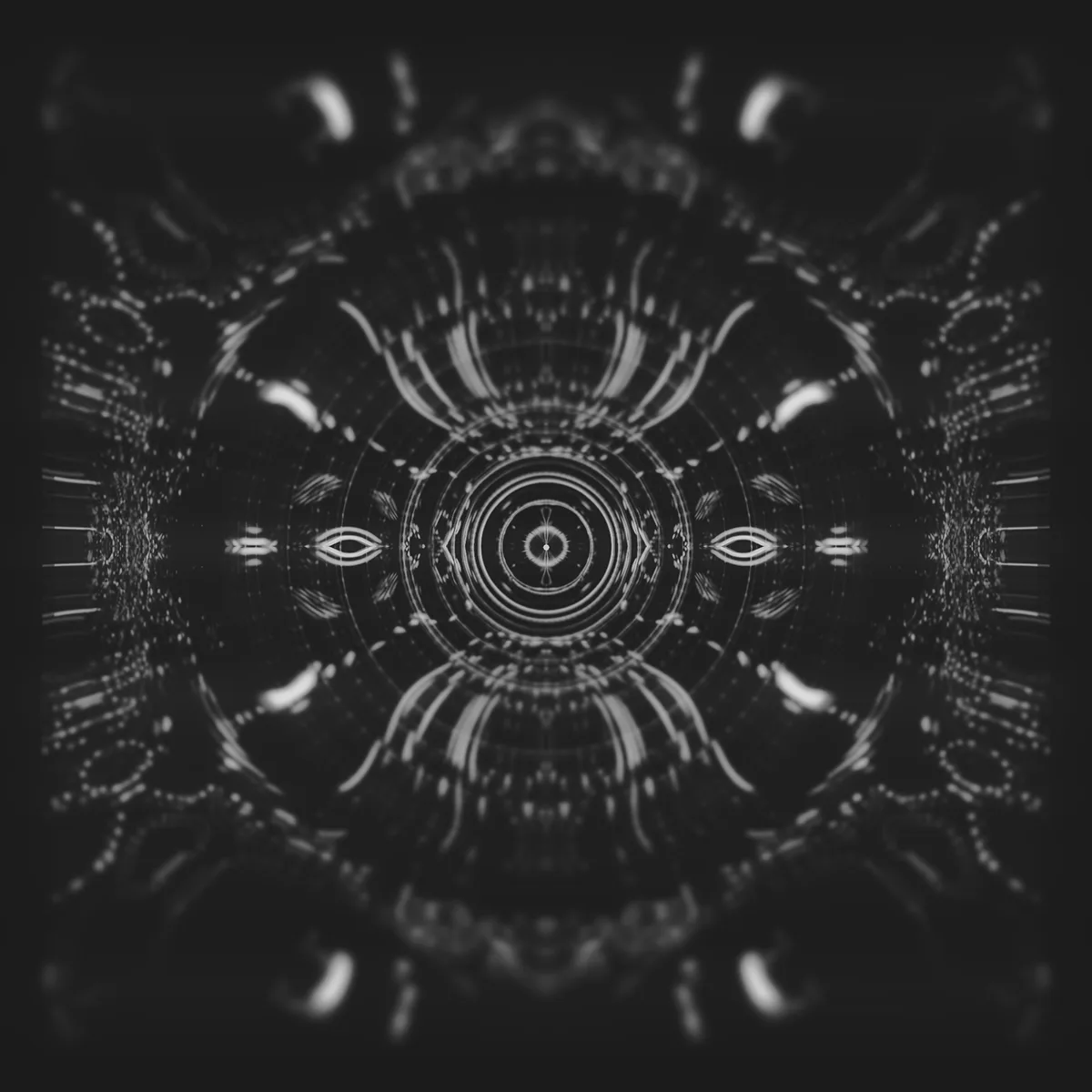 reakt0r — symmetrical grey radial pattern of rings, arcs and eye shapes on dark grey